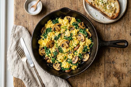 Spinach and mushroom egg scramble with orange juice on the side - first-trimester iron breakfast